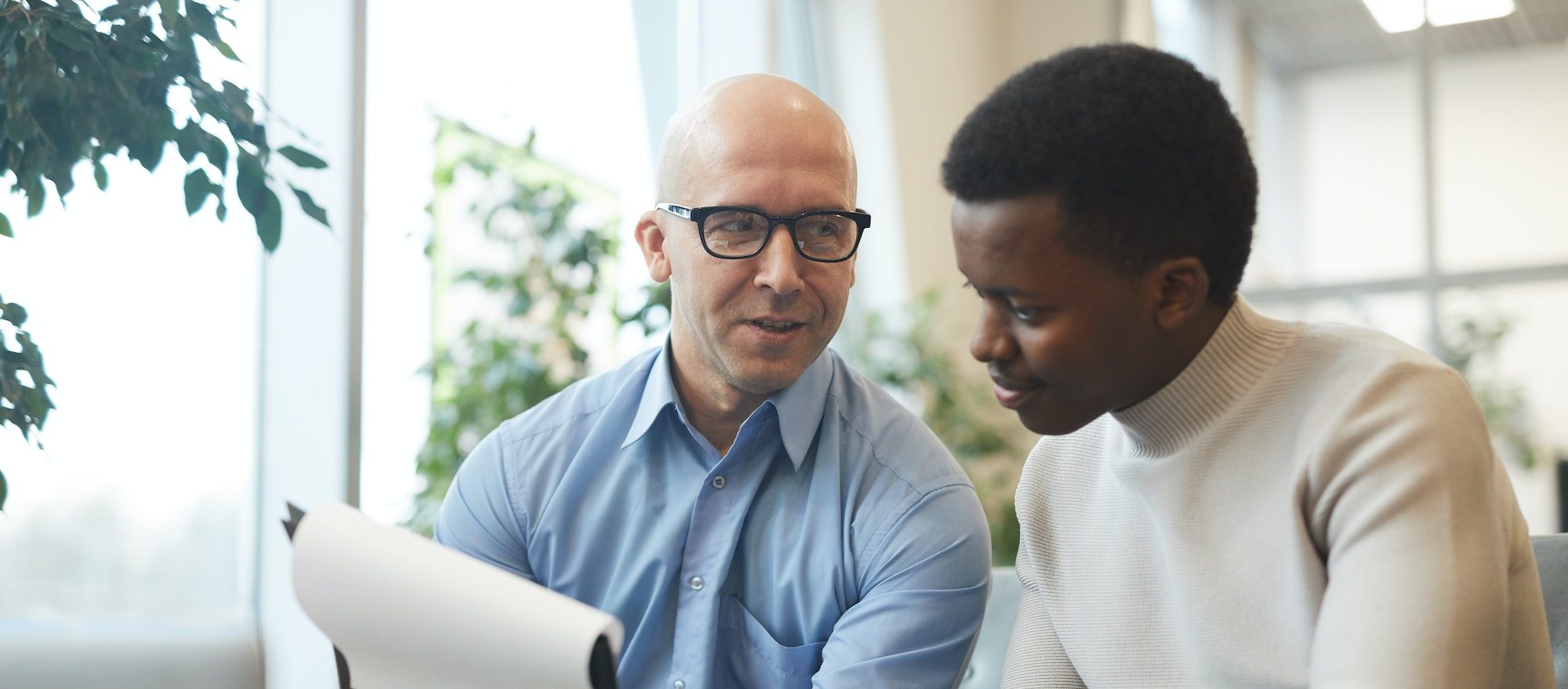 business people discussing documents e1661523212455