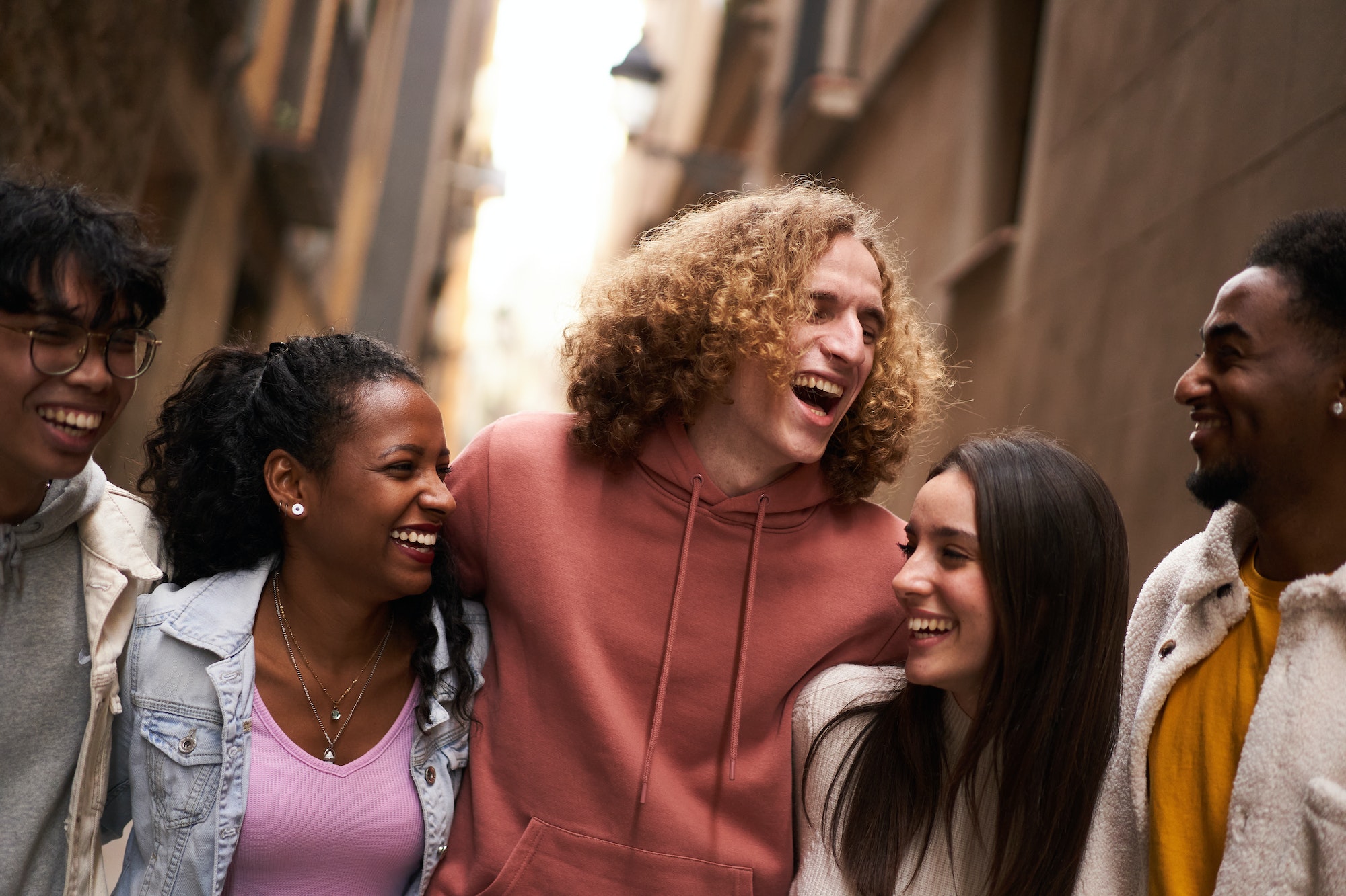 group of happy friends having fun together outdoors mixed race people laughing making community