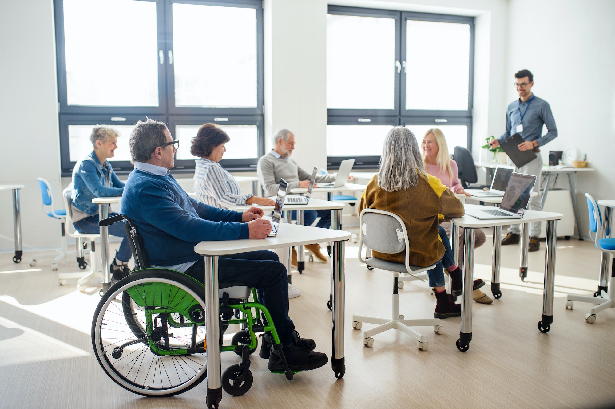 group of senior people attending computer and technology education class