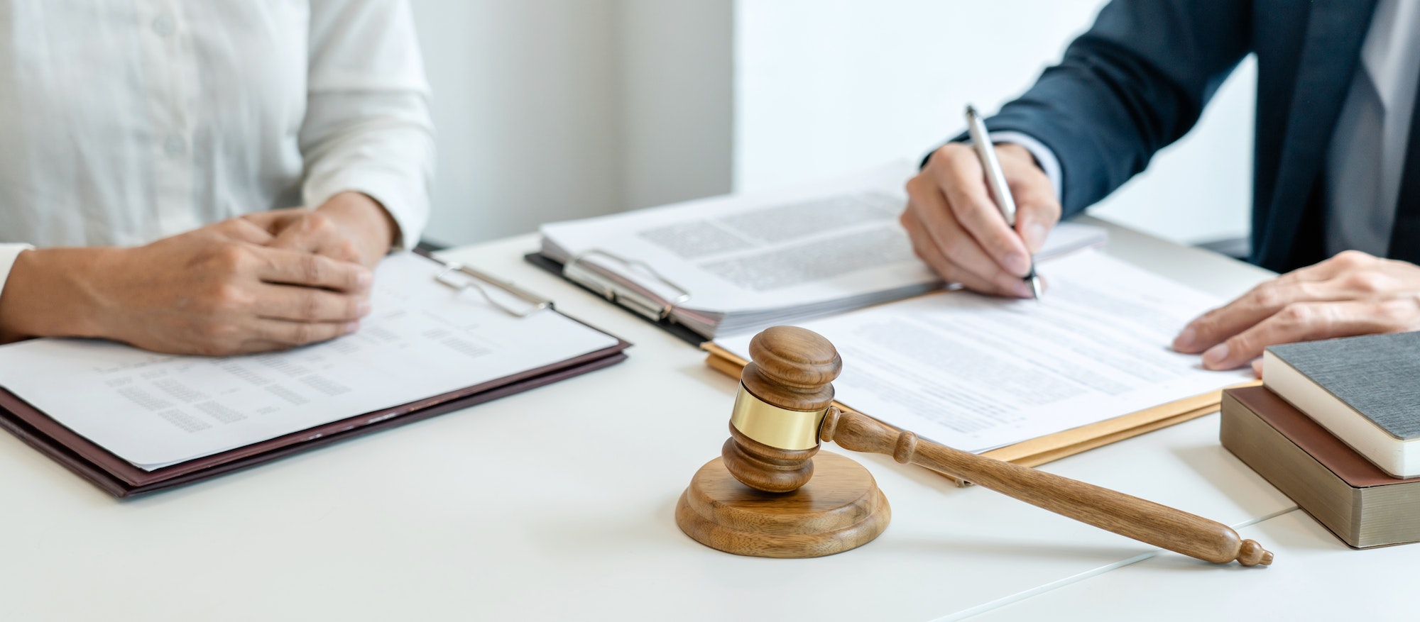 male lawyer is pointing on legal document to explaining about consultation terms and condition