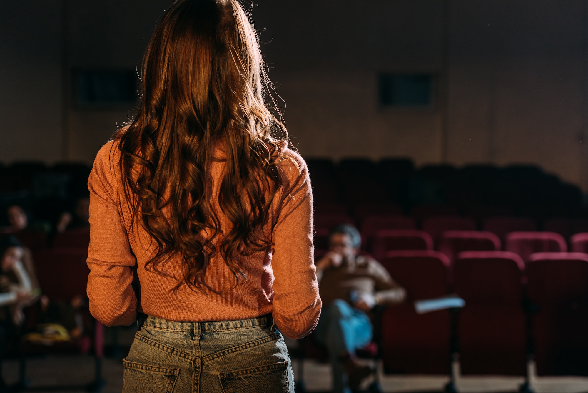 back view of actress and stage director in theater