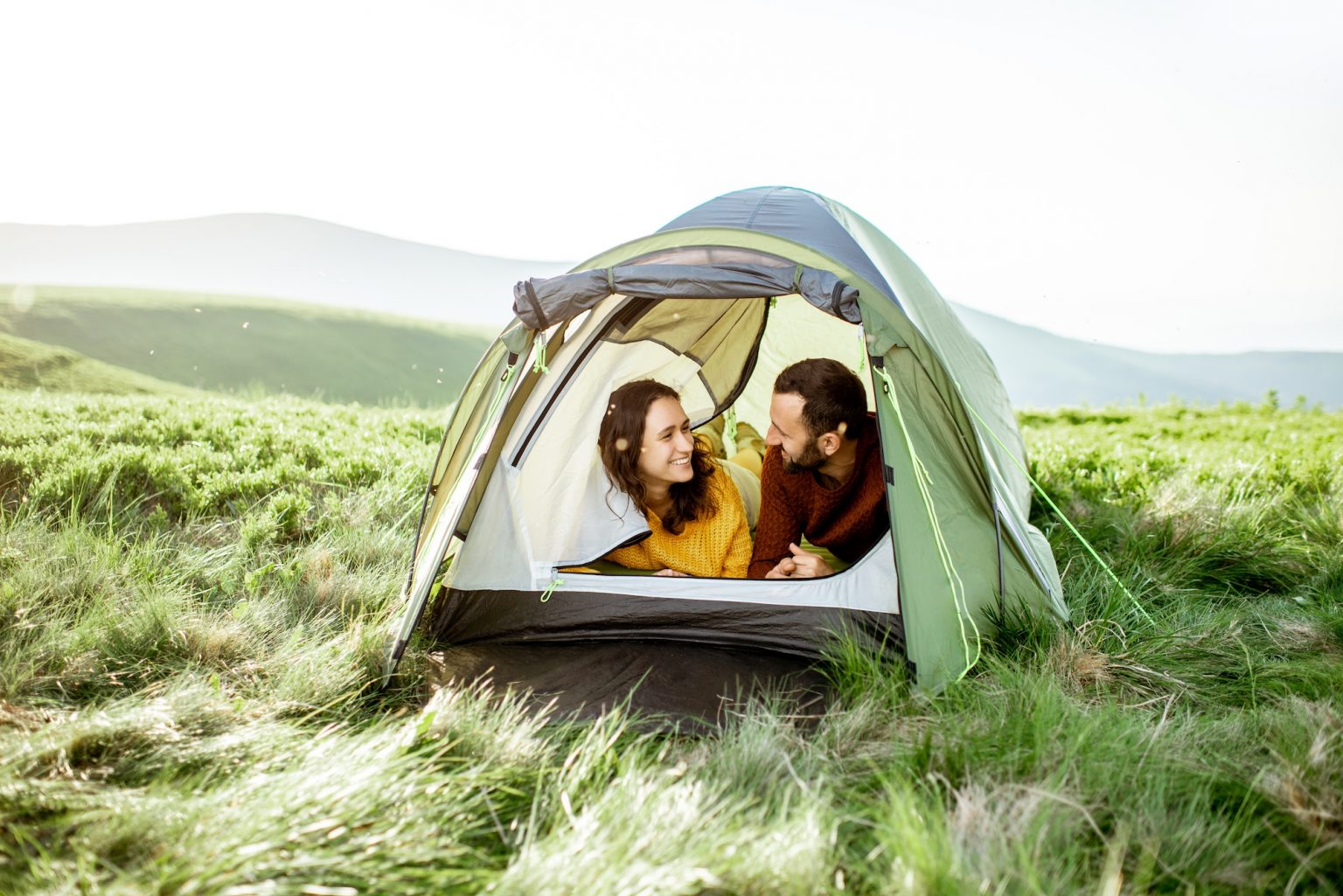 couple with tent in the mountains